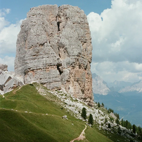 The jagged five limestone pillars of Cinque Torri under a blue sky