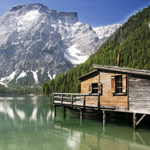 Turquoise waters of Lago di Braies surrounded by dramatic Dolomite peaks