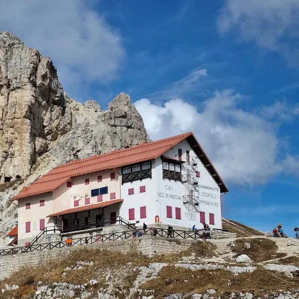 Rifugio Auronzo sitting at the base of the Tre Cime di Lavaredo at sunset.