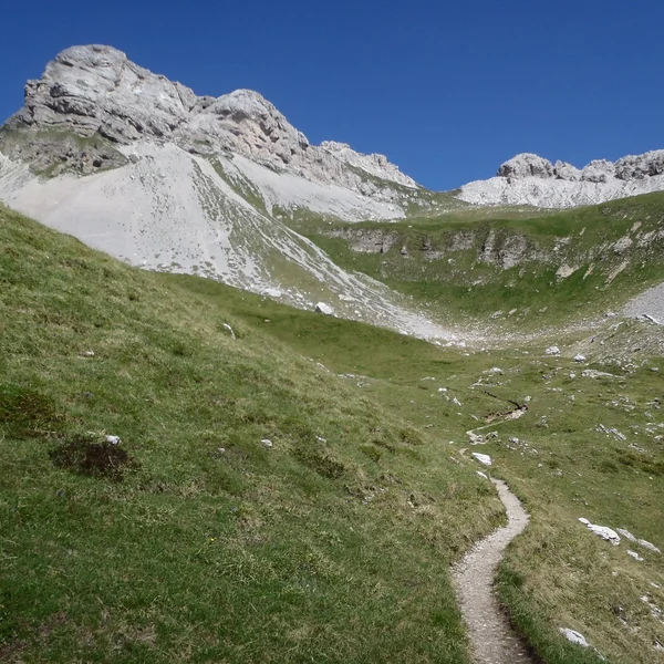 Rugged mountain cirque of Van de Zita with steep grassy slopes